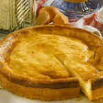 Old-Fashioned German Cheesecake (Altdeutscher Käsekuchen) – a golden, creamy baked cheesecake in a springform tin with a slice cut out, showing its soft quark filling and rich buttery crust.