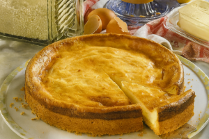 Old-Fashioned German Cheesecake (Altdeutscher Käsekuchen) – a golden, creamy baked cheesecake in a springform tin with a slice cut out, showing its soft quark filling and rich buttery crust.